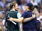 Italy's Jannik Sinner (R) embraces Kazakhstan's Alexander Bublik
