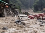 A vehicle stuck in the Manalsu drain, flowing in spate, after heavy monsoon rain, at Manali in Kullu district.