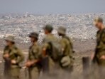 Israeli soldiers overlooking destroyed buildings in the northern Gaza Strip last month. Israeli soldiers overlooking destroyed buildings in the northern Gaza Strip last month.