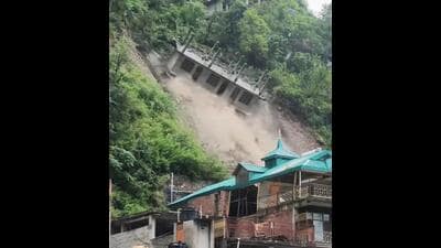 A building under construction collapsing due to a landslide at Anni in Kullu district on Tuesday. There was no casualty. (HT Photo)