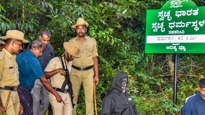 Security personnel near a site of an alleged burial related to the Dharmasthala mass burial case, at Dharmasthala, in Dakshina Kannada district. (PTI) Security personnel near a site of an alleged burial related to the Dharmasthala mass burial case, at Dharmasthala, in Dakshina Kannada district. (PTI)