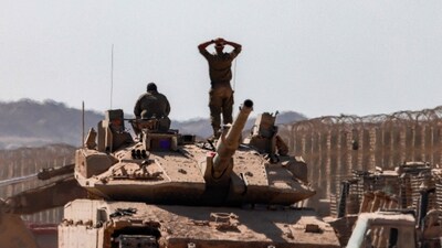 An Israeli army soldier stands atop the turret of a Merkava main battle tank next to another soldier while positioned near armoured military bulldozers along the border with the Gaza Strip in southern Israel on September 2, 2025. (AFP) An Israeli army soldier stands atop the turret of a Merkava main battle tank next to another soldier while positioned near armoured military bulldozers along the border with the Gaza Strip in southern Israel on September 2, 2025. (AFP)
