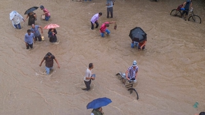 Another aerial view of the commuters make their way through a waterlogged road amid rainfall, in Gurugram. (PTI) Another aerial view of the commuters make their way through a waterlogged road amid rainfall, in Gurugram. (PTI)