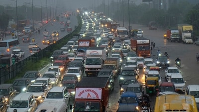 Vehicles remained stuck in a traffic jam along the Delhi-Gurugram expressway amid rainfall in Gurugram on Monday. (PTI) Vehicles remained stuck in a traffic jam along the Delhi-Gurugram expressway amid rainfall in Gurugram on Monday. (PTI)