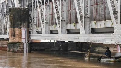 On Tuesday, the Yamuna flowed above the danger mark after incessant heavy rainfall at Loha Pul (Old Iron Bridge) in New Delhi. (PTI) On Tuesday, the Yamuna flowed above the danger mark after incessant heavy rainfall at Loha Pul (Old Iron Bridge) in New Delhi. (PTI)