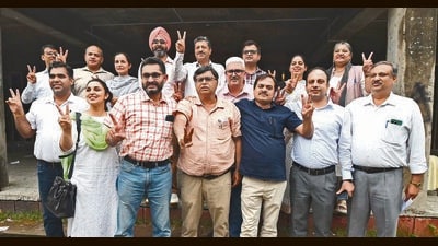 Panjab University Teachers Association president AS Naura (in chequered shirt) with his panel members after declaration of results in Chandigarh on Tuesday. (Keshav Singh/HT) Panjab University Teachers Association president AS Naura (in chequered shirt) with his panel members after declaration of results in Chandigarh on Tuesday. (Keshav Singh/HT)