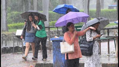 Students take cover under an umbrella at Panjab University amid rain on Tuesday. (Keshav Singh/HT) Students take cover under an umbrella at Panjab University amid rain on Tuesday. (Keshav Singh/HT)
