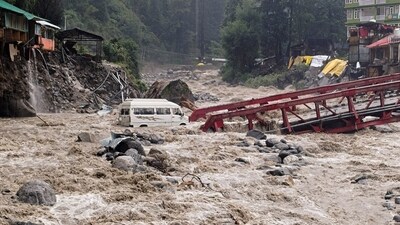 A vehicle stuck in the Manalsu drain, flowing in spate, after heavy monsoon rain, at Manali in Kullu district. (PTI)