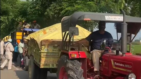 A convoy of tractor-trailers carrying relief material lined up in Kapurthala, one of the worst flood-affected districts of Punjab. (HT Photo)