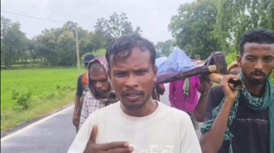 A video of the incident, shared widely on social media, shows four men walking along a road carrying woman’s body on a cot. (Video grab)
