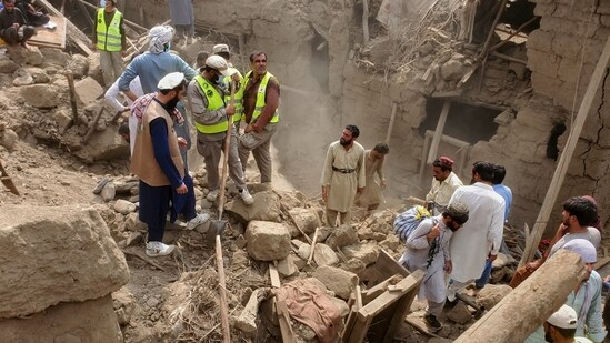 Civil defense workers, locals, and army soldiers clear rubble of a collapsed house after a powerful 6.0-magnitude earthquake struck eastern Afghanistan on Sunday. (AP)