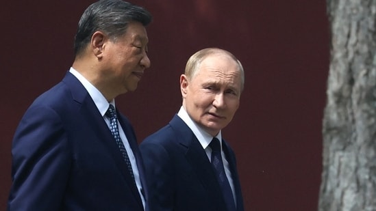 Russia's President Vladimir Putin and China's President Xi Jinping walk at Zhongnanhai leadership compound in Beijing on September 2, 2025. (AFP)