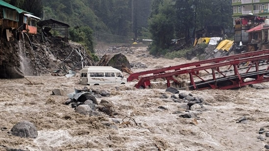 A vehicle stuck in the Manalsu drain, flowing in spate, after heavy monsoon rain, at Manali in Kullu district. (PTI)