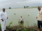 Farmers show submerged fields at Bhaini Chandrapal village in Meham subdivision, in Rohtak, on Tuesday. (Manoj Dhaka/HT) Farmers show submerged fields at Bhaini Chandrapal village in Meham subdivision, in Rohtak, on Tuesday. (Manoj Dhaka/HT)