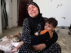 The grandmother of three-year-old Ibrahim al-Mabhuh, who survived an Israeli air strike on a house that killed his parents and two sisters, according to medics, holds him in Gaza City, September 3, 2025.