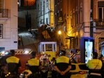 Police officers look at the wreckage of the Lisbon's Gloria funicular railway car that derailed and crashed, resulting in fatalities and injuries, in Lisbon, Portugal, September 3, 2025. 