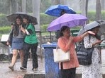 Students take cover under an umbrella at Panjab University amid rain on Tuesday. (Keshav Singh/HT) Students take cover under an umbrella at Panjab University amid rain on Tuesday. (Keshav Singh/HT)