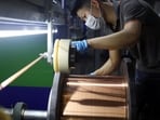 An employee works on the production line for copper flat wire at the Wellascent factory in Ganzhou, China.