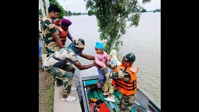 Border Security Force personnel evacuating a child from a flood-hit area in Ferozepur district of Punjab. (PTI Photo)