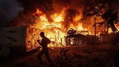 California wildfire: A residents work to stop flames from a burning home from spreading to a neighboring house as the 6-5 Fire burns through the Chinese Camp community of Tuolumne County, California, on Tuesday, September 2, 2025. AP Photo/Noah Berger California wildfire: A residents work to stop flames from a burning home from spreading to a neighboring house as the 6-5 Fire burns through the Chinese Camp community of Tuolumne County, California, on Tuesday, September 2, 2025. AP Photo/Noah Berger
