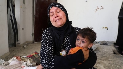 The grandmother of three-year-old Ibrahim al-Mabhuh, who survived an Israeli air strike on a house that killed his parents and two sisters, according to medics, holds him in Gaza City, September 3, 2025. (REUTERS)