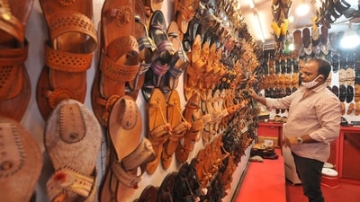Kolhapuri chappals on display in a store. The GST on footwear and apparel priced up to  ₹2,500 will now be taxed at 5%, as against 12% earlier. (HT)