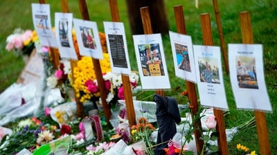 Maine mass shooting: Rain soaked memorials for those who died in a mass shooting sit along the roadside by Schemengees Bar & Grille, Oct. 30, 2023, in Lewiston, Maine. (AP Photo/Matt York, File) (AP) Maine mass shooting: Rain soaked memorials for those who died in a mass shooting sit along the roadside by Schemengees Bar & Grille, Oct. 30, 2023, in Lewiston, Maine. (AP Photo/Matt York, File) (AP)