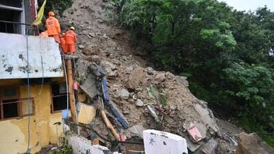 Rescuers at the site where two people were feared buried as two houses collapsed following a landslide in the Inner Akhara Bazaar area of Kullu town early on Wednesday. (Aqil Khan/HT) Rescuers at the site where two people were feared buried as two houses collapsed following a landslide in the Inner Akhara Bazaar area of Kullu town early on Wednesday. (Aqil Khan/HT)