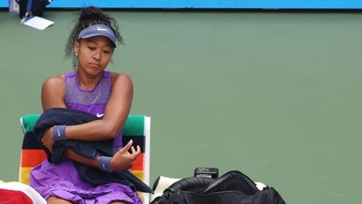 Japan's Naomi Osaka during her round of 16 match against Coco Gauff of the U.S. as her Labubu doll is seen (REUTERS)