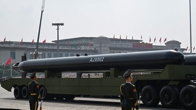 The parade featured two new, extra-large torpedo-shaped unmanned underwater vehicles -- the AJX002 and the HSU100 -- carried on top of long trucks. According to the BBC, the AJX002 measures up to 20m (65ft) in length and could possibly do surveillance and reconnaissance missions. (AFP)