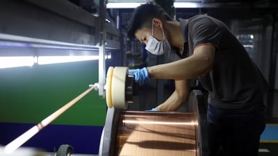 An employee works on the production line for copper flat wire at the Wellascent factory in Ganzhou, China. (Reuters)