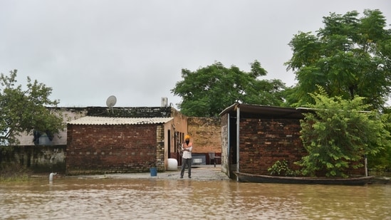 A resident speaks on his mobile phone after his area was cut off by floodwaters following heavy rains in Kapurthala district of northern state of Punjab, India, Tuesday, Sept. 2, 2025. (AP Photo/Prabhjot Gill) (AP)