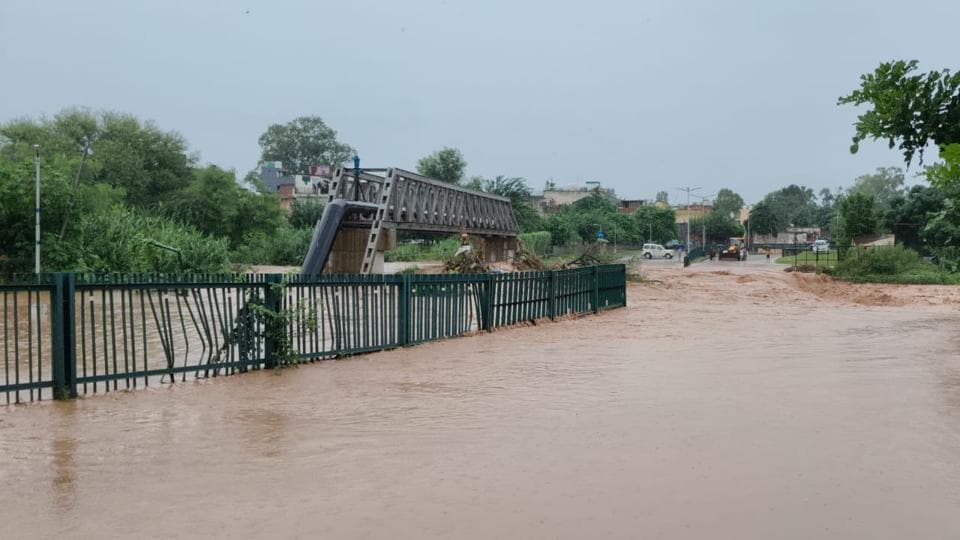 Water flowing over the bridge at Bapu Dham in Sector 26, Chandigarh, after the Sukhna Lake floodgates were opened on Wednesday morning. (Ravi Kumar/HT) Water flowing over the bridge at Bapu Dham in Sector 26, Chandigarh, after the Sukhna Lake floodgates were opened on Wednesday morning. (Ravi Kumar/HT)
