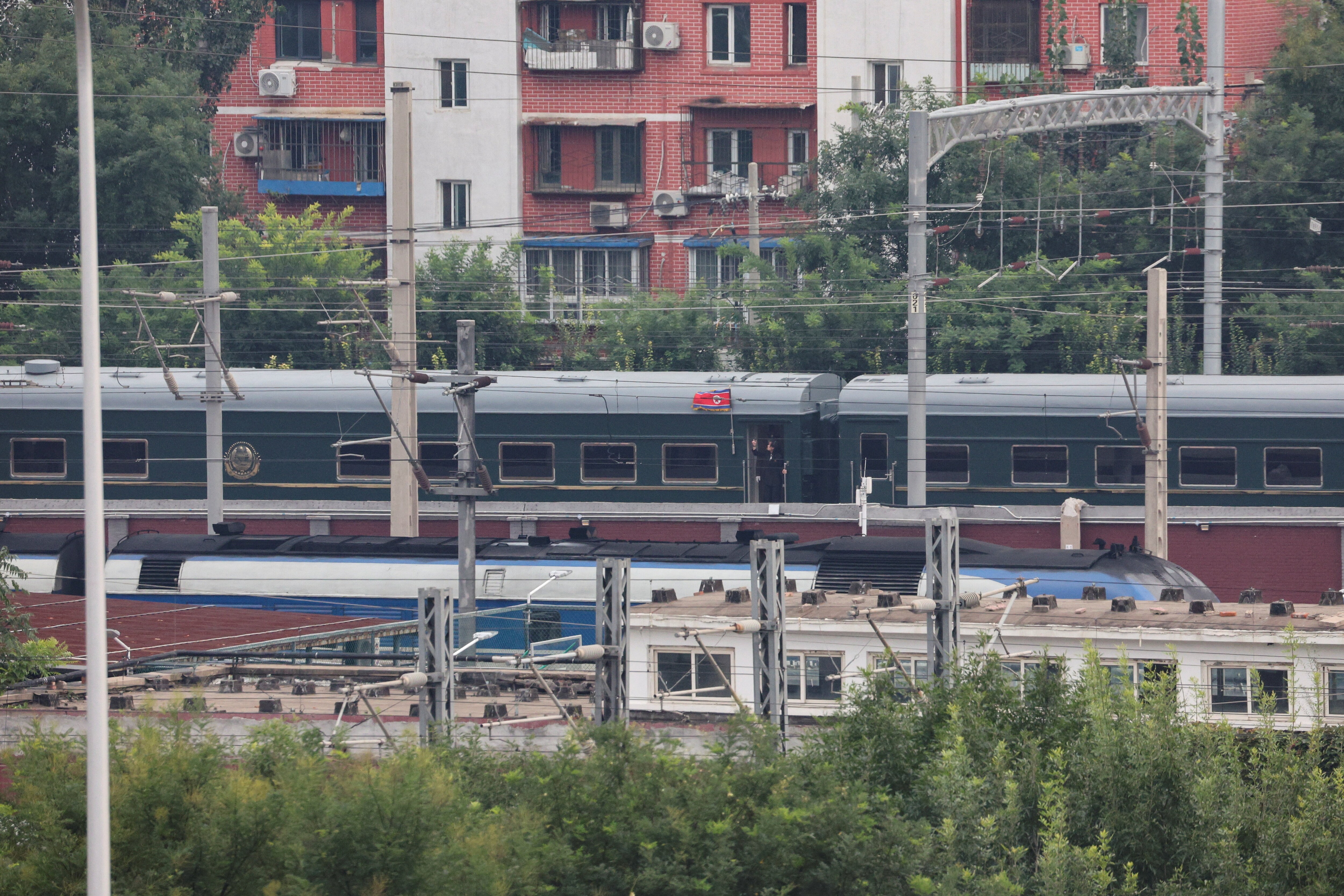 North Korea's flag flutters on side of the heavily-armoured green train, carrying Kim Jong Un, as it arrives in Beijing, China, for the military parade. (Reuters)