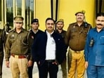 A photo displayed on Saurabh Tripathi’s social media handle shows him posing with police bodyguards, private security and a PA. (SOURCED) A photo displayed on Saurabh Tripathi’s social media handle shows him posing with police bodyguards, private security and a PA. (SOURCED)