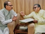 Punjab governor Gulab Chand Kataria submitting his report on the flood situation in the five border districts to Union agriculture minister Shivraj Chouhan at the airport in Amritsar on Thursday. (HT Photo)