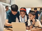 An Apple Koregaon Park employee demonstrates iPad's functionality to school students. An Apple Koregaon Park employee demonstrates iPad's functionality to school students.