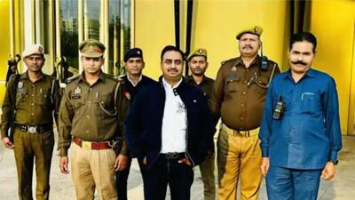 A photo displayed on Saurabh Tripathi’s social media handle shows him posing with police bodyguards, private security and a PA. (SOURCED) A photo displayed on Saurabh Tripathi’s social media handle shows him posing with police bodyguards, private security and a PA. (SOURCED)