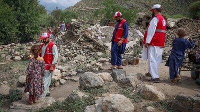 Red Crescent volunteers walk next to damaged houses as they reach Lulam village to help the victims following a deadly magnitude-6 earthquake that struck Afghanistan on Sunday, in Nurgal district, Kunar province, Afghanistan, September 3, 2025. (REUTERS)