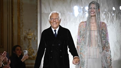 Italian designer Giorgio Armani acknowledges the applause with Latvian model Agnes Zogla (AFP)