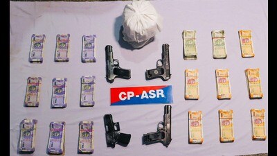 Heroin, weapons and drug money seized by Amritsar police. (HT Photo) Heroin, weapons and drug money seized by Amritsar police. (HT Photo)