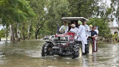 Union agriculture minister Shivraj Chouhan with minister of state for railways Ravneet Singh Bittu, BJP national general secretary Tarun Chugh and Punjab BJP chief Sunil Jakhar riding a tractor in flood-affected Ramdass in Amritsar district on Thursday. (PTI Photo) Union agriculture minister Shivraj Chouhan with minister of state for railways Ravneet Singh Bittu, BJP national general secretary Tarun Chugh and Punjab BJP chief Sunil Jakhar riding a tractor in flood-affected Ramdass in Amritsar district on Thursday. (PTI Photo)