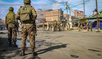 Security personnel stand guard along a street in Imphal on June 9, 2025, after violence erupted (AFP FILE PHOTO) Security personnel stand guard along a street in Imphal on June 9, 2025, after violence erupted (AFP FILE PHOTO)