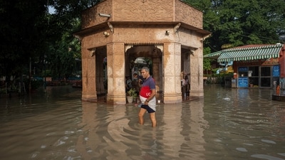 A man walking through a flooded cremation ground after a rise in the water level of the river Yamuna, in New Delhi. (Reuters)