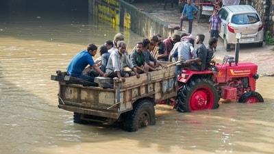 New Delhi residents were travelling from a tractor ride after the water from the raging Yamuna River flooded the area near Yamuna Bazar. (PTI) New Delhi residents were travelling from a tractor ride after the water from the raging Yamuna River flooded the area near Yamuna Bazar. (PTI)