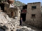 A boy stands in front of houses damaged by a deadly earthquake that struck Afghanistan's Kunar and Nangarhar provinces, at Masud village in Nurgal district, Kunar province, Afghanistan.