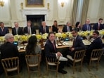 President Donald Trump hosts a dinner with first lady Melania Trump in the State Dinning Room of the White House, Thursday.