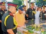 Chief minister Yogi Adityanath along with Chief of Defence Staff (CDS) General Anil Chauhan (extreme left), reviews the proposed model of Gorkha Museum in Gorakhpur on Thursday. (HT)