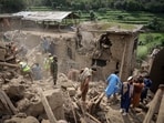 Rescue workers clear debris of a damaged house after a deadly magnitude-6 earthquake that struck Afghanistan
