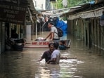 Some people use a boat as others walk through a flooded Monastery Market as the Yamuna river continues to flow in spate in Delhi Some people use a boat as others walk through a flooded Monastery Market as the Yamuna river continues to flow in spate in Delhi